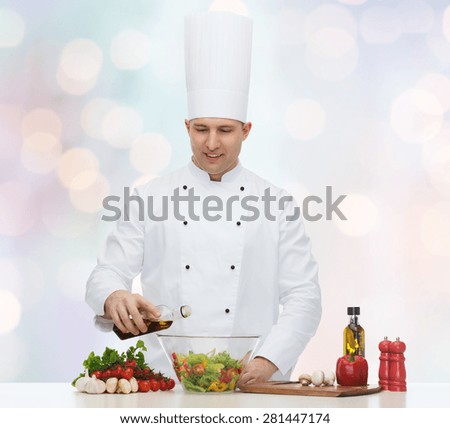 profession, vegetarian, food and people concept - happy male chef cooking salad over blue lights background