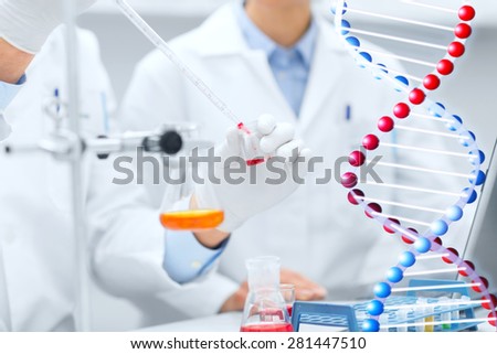 science, chemistry, technology, biology and people concept - close up of scientists hands with pipette filling test tube making research in clinical laboratory
