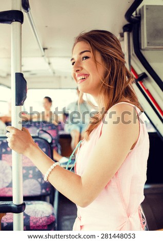 travel, vacation, summer, transport and people concept - smiling teenage girl going by bus