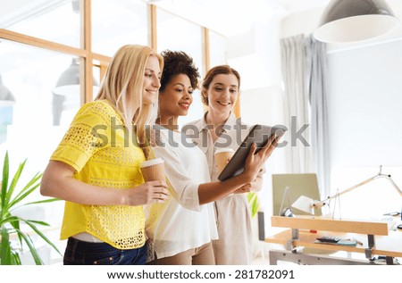 business, technology, people and teamwork concept - happy creative team with tablet pc computer in office