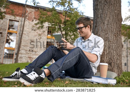 education, people, technology , drinks and learning concept - happy teenage boy with tablet pc computer drinking coffee from paper cup at campus