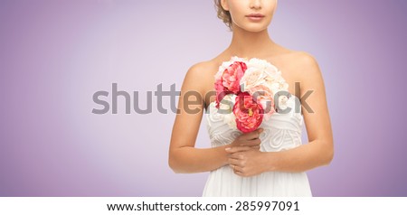 wedding, holidays, people and celebration concept- bride or woman with bouquet of flowers over violet background