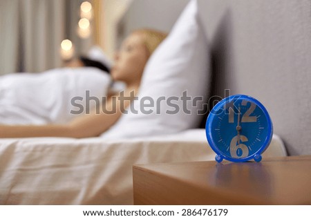 morning, and people concept - close up of alarm clock in bedroom