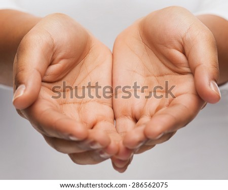people and advertisement concept - close up of womans cupped hands showing something