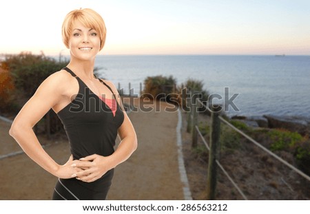 people, fitness and sport concept - happy woman jogging outdoors over beach sunset background