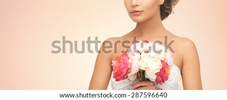 wedding, holidays, people and celebration concept- bride or woman with bouquet of flowers over beige background