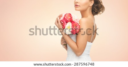 wedding, holidays, people and celebration concept- bride or woman with bouquet of flowers over beige background
