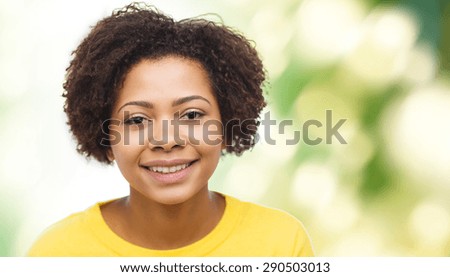people, race, ethnicity and portrait concept - happy african american young woman face over green natural background