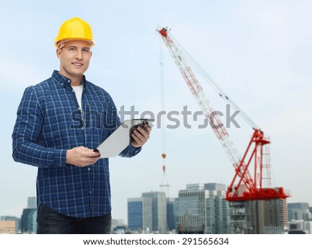 repair, construction, building, people and maintenance concept - smiling male builder or manual worker in helmet with clipboard over city construction site background