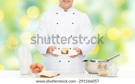cooking, haute cuisine, food and people concept - close up of happy male chef cook with flour, eggs and butter on table baking dessert over green summer holidays lights background