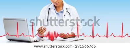 healthcare, medical diagnosis and technology concept - african female doctor with laptop pc computer looking at medical report over blue background with red heart shape and cardiogram