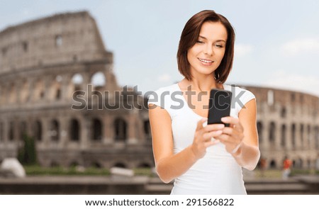 people, technology, tourism and travel concept - young woman taking selfie with smartphone over coliseum background
