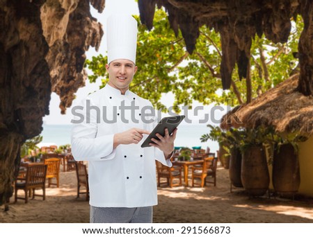 cooking, profession and people concept - happy male chef cook holding tablet pc computer over restaurant lounge on beach