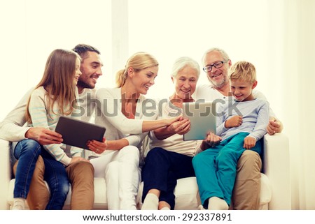 family, generation, technology and people concept - smiling family with tablet pc computers at home
