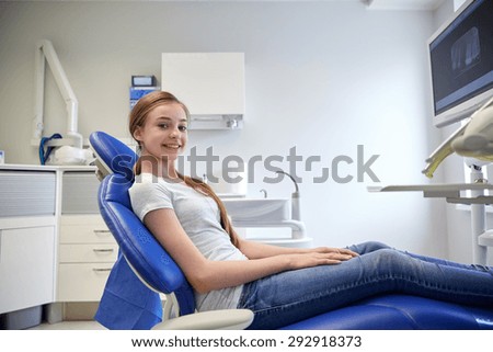 people, medicine, stomatology, dentistry and health care concept - happy patient girl at dental clinic office
