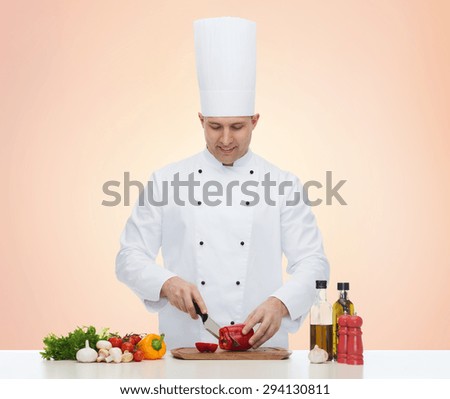 cooking, profession, vegetarian, food and people concept - happy male chef chopping pepper over beige background
