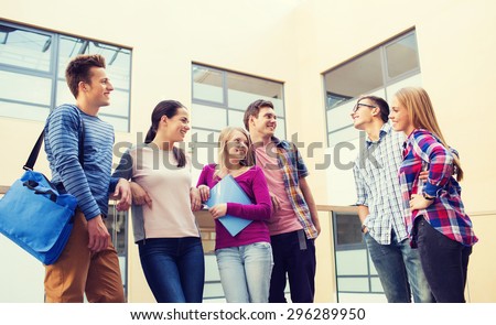 friendship, people and education concept - group of smiling students outdoors