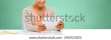 education, school, people and learning concept - smiling student girl with tablet pc computer over green chalk board background