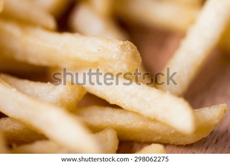 junk-food, fast food and eating concept - close up of french fries on table