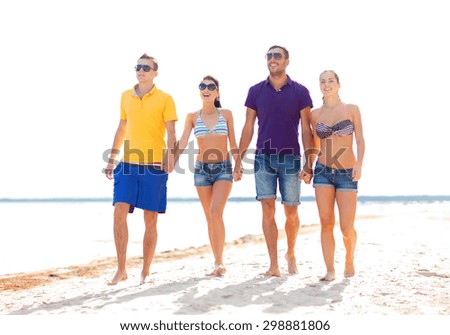 summer holidays, vacation, tourism, travel and people concept - group of happy friends holding hands and walking along beach