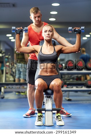Fit woman flexing her muscles stock photo - OFFSET