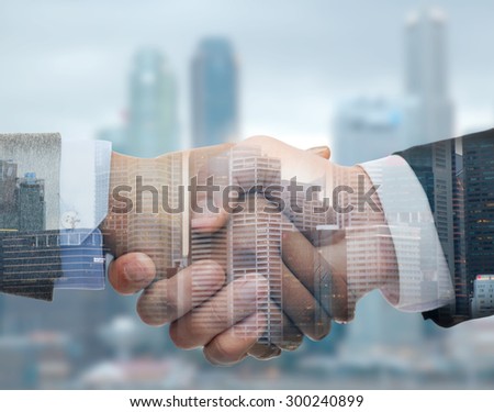 business, partnership, cooperation and gesture concept - businessman and businesswoman shaking hands over city double exposure background