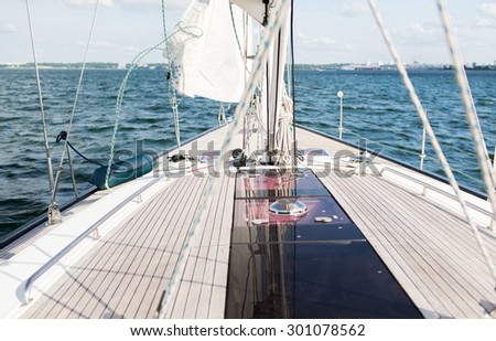 vacation, travel, cruise and leisure concept - close up of sailboat or sailing yacht deck and sea