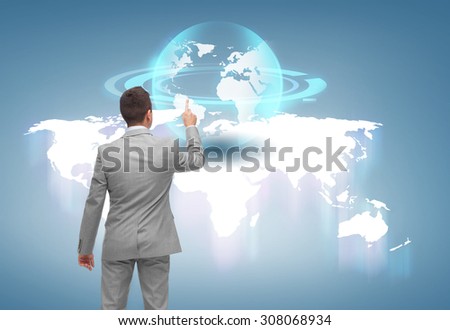 business, people and technology concept - businessman pointing finger or touching virtual globe projection over blue background from back