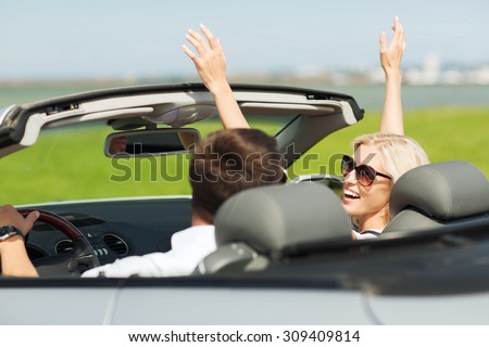 transport, road trip, leisure, couple and people concept - happy man and woman driving in cabriolet car outdoors