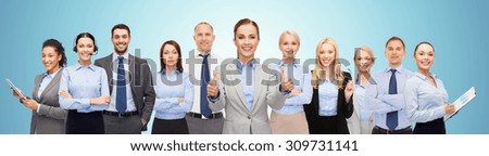 business, people, corporate, teamwork and office concept - group of happy businesspeople showing thumbs up over blue background