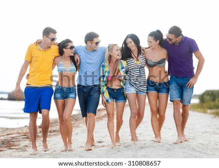 summer holidays, vacation, tourism, travel and people concept - group of happy friends talking and walking along beach