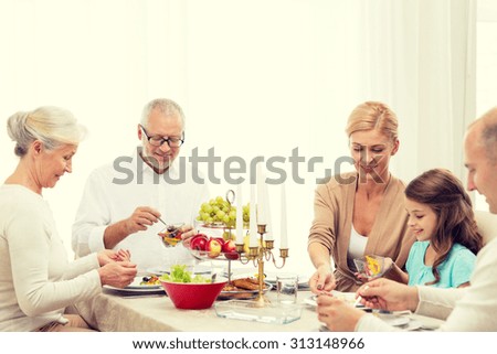 family, holidays, thanksgiving, thanksgiving, generation and people concept - smiling family having dinner at home
