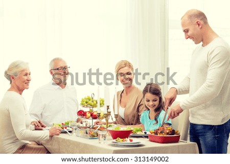 family, holidays, thanksgiving, generation and people concept - smiling family having dinner at home