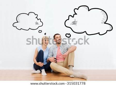 home, people, repair, moving and real estate concept - happy couple of man and woman sitting on floor at new place with empty blank text bubbles