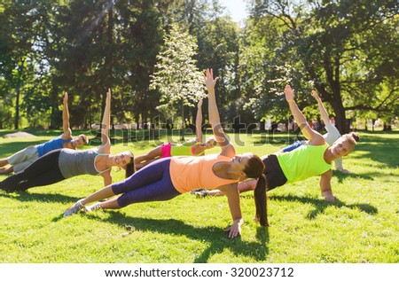 fitness, sport, friendship and healthy lifestyle concept - group of happy teenage friends exercising at boot camp