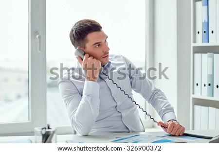 business, people and communication concept - angry businessman calling on phone in office