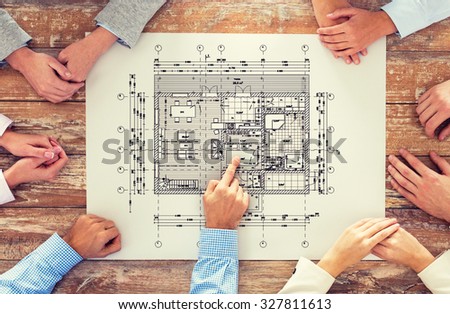business, people, architecture and team work concept - close up of architects team hands pointing finger to blueprint at office table