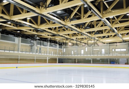 winter, sport, architecture and leisure concept - ice skating rink indoors