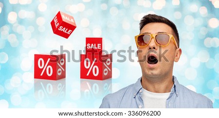 emotions, shopping, sale, discount and people concept - face of scared or surprised middle aged latin man in shirt and sunglasses over blue holidays lights and red percentage signs background