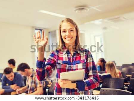 education, high school, gesture and people concept - group of smiling students with tablet pc computer waving hand in lecture hall