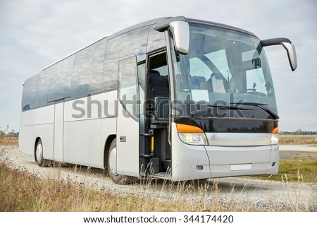 travel, tourism, road trip and passenger transport - tour bus staying outdoors
