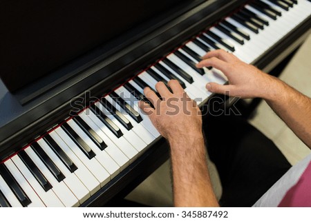 music, people, art, musical instruments and entertainment concept - close up of male hands playing piano