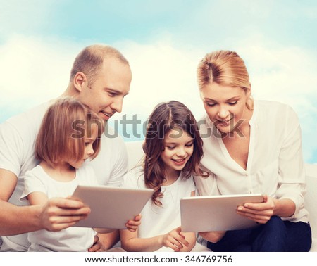 family, technology and people - smiling mother, father and little girls with tablet pc computers over blue sky background