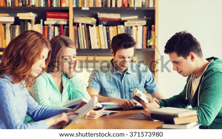 students with books preparing to exam in library