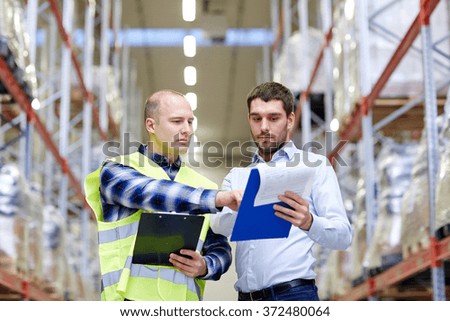 worker and businessmen with clipboard at warehouse