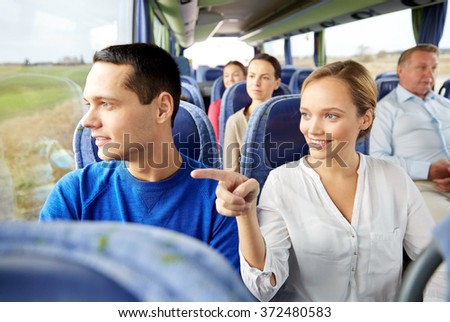 happy couple or passengers in travel bus