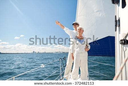 senior couple sailing on boat or yacht in sea