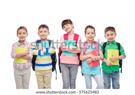 childhood, preschool education, learning and people concept - group of happy smiling little children with school bags and notebooks