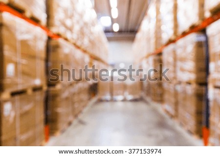 logistic, storage, shipment, industry and manufacturing concept - cargo boxes storing at warehouse shelves bokeh