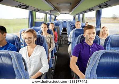 transport, tourism, road trip and people concept - group of passengers or tourists in travel bus